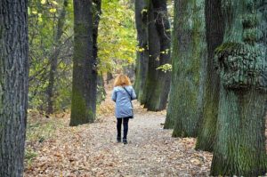 woman walking in woods alone